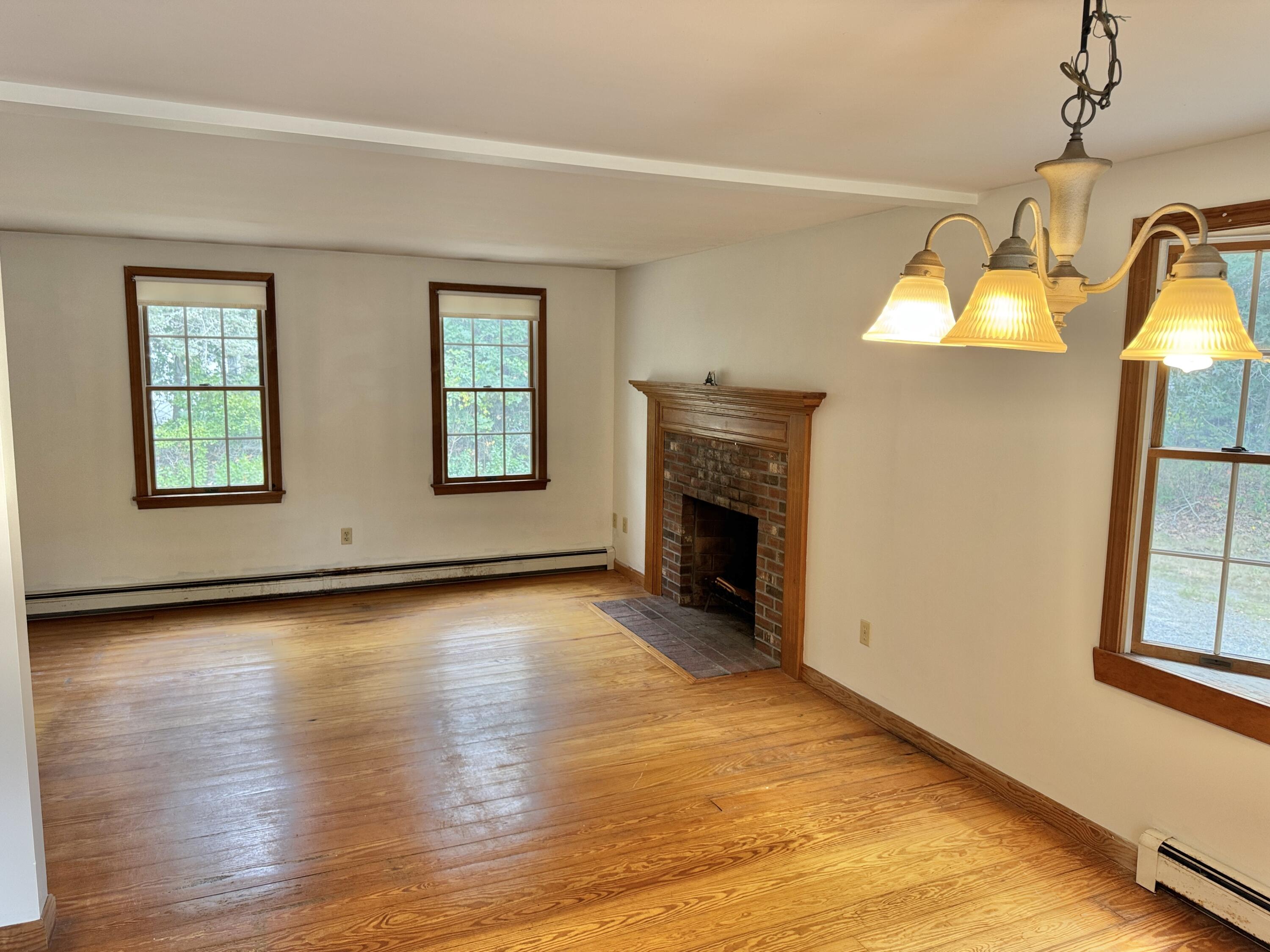 255 Massasoit Road Eastham, MA 02642 - Photo 13 of 25 a view of an empty room with window and wooden floor