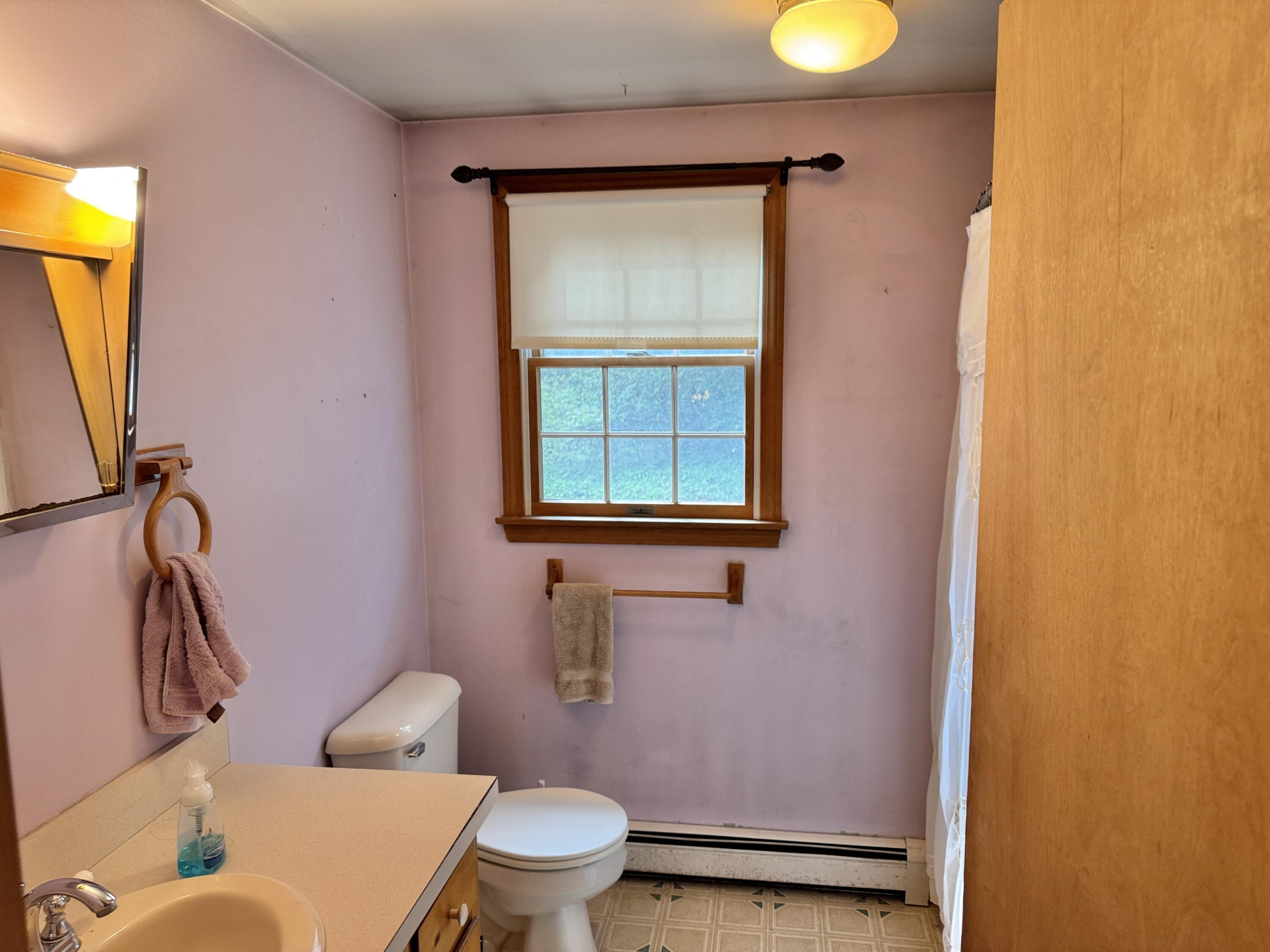 255 Massasoit Road Eastham, MA 02642 - Photo 16 of 25 a bathroom with a toilet sink and mirror