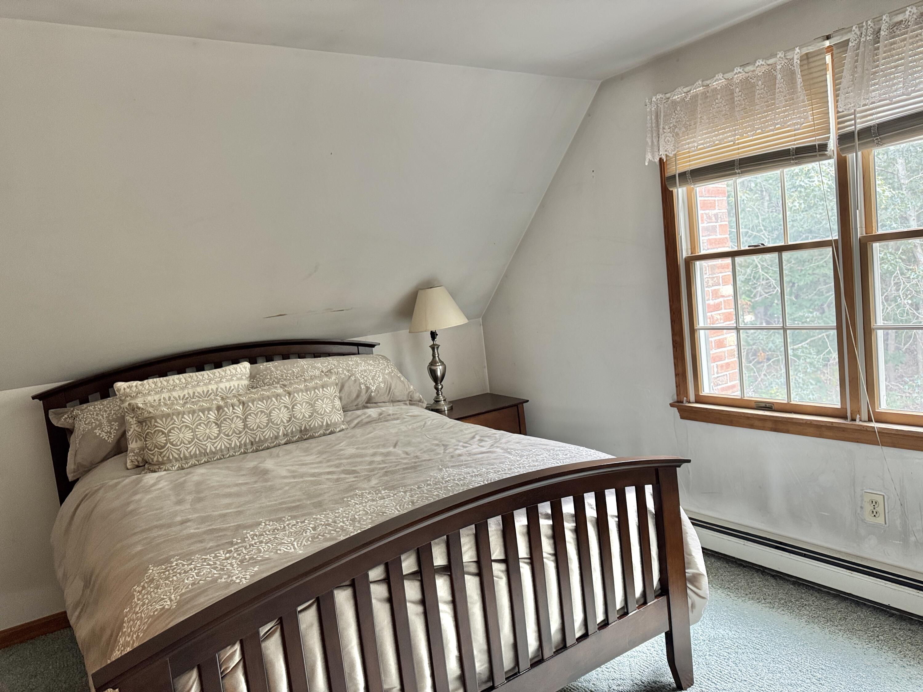 255 Massasoit Road Eastham, MA 02642 - Photo 17 of 25 a bedroom with a bed and a window