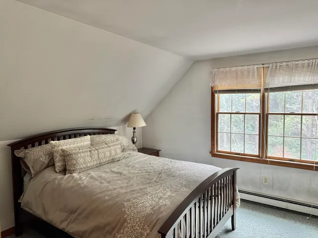 a bedroom with a bed and window