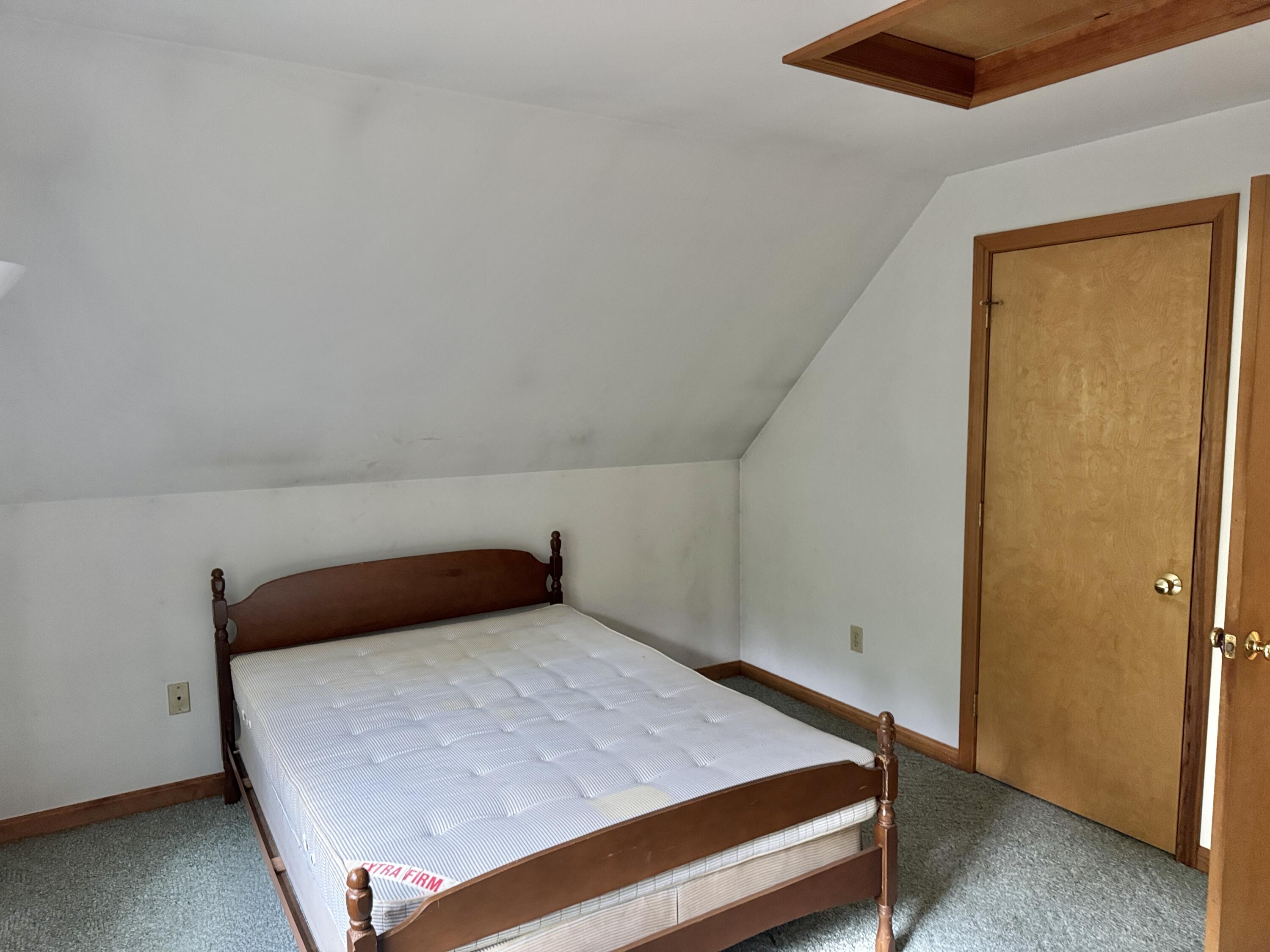 255 Massasoit Road Eastham, MA 02642 - Photo 19 of 25 a bedroom with a bed and wooden floor