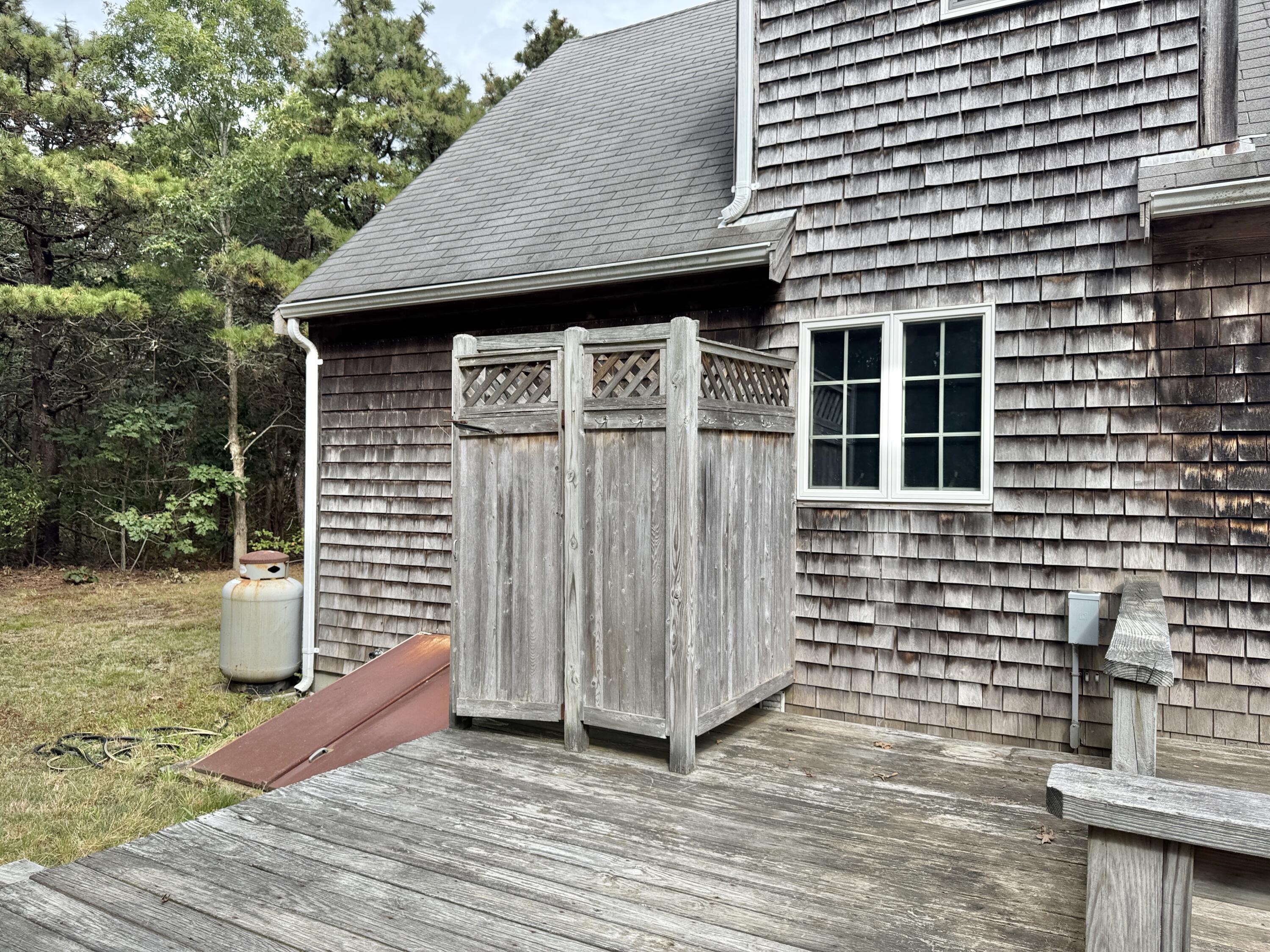 255 Massasoit Road Eastham, MA 02642 - Photo 23 of 25 a view of a house with wooden deck