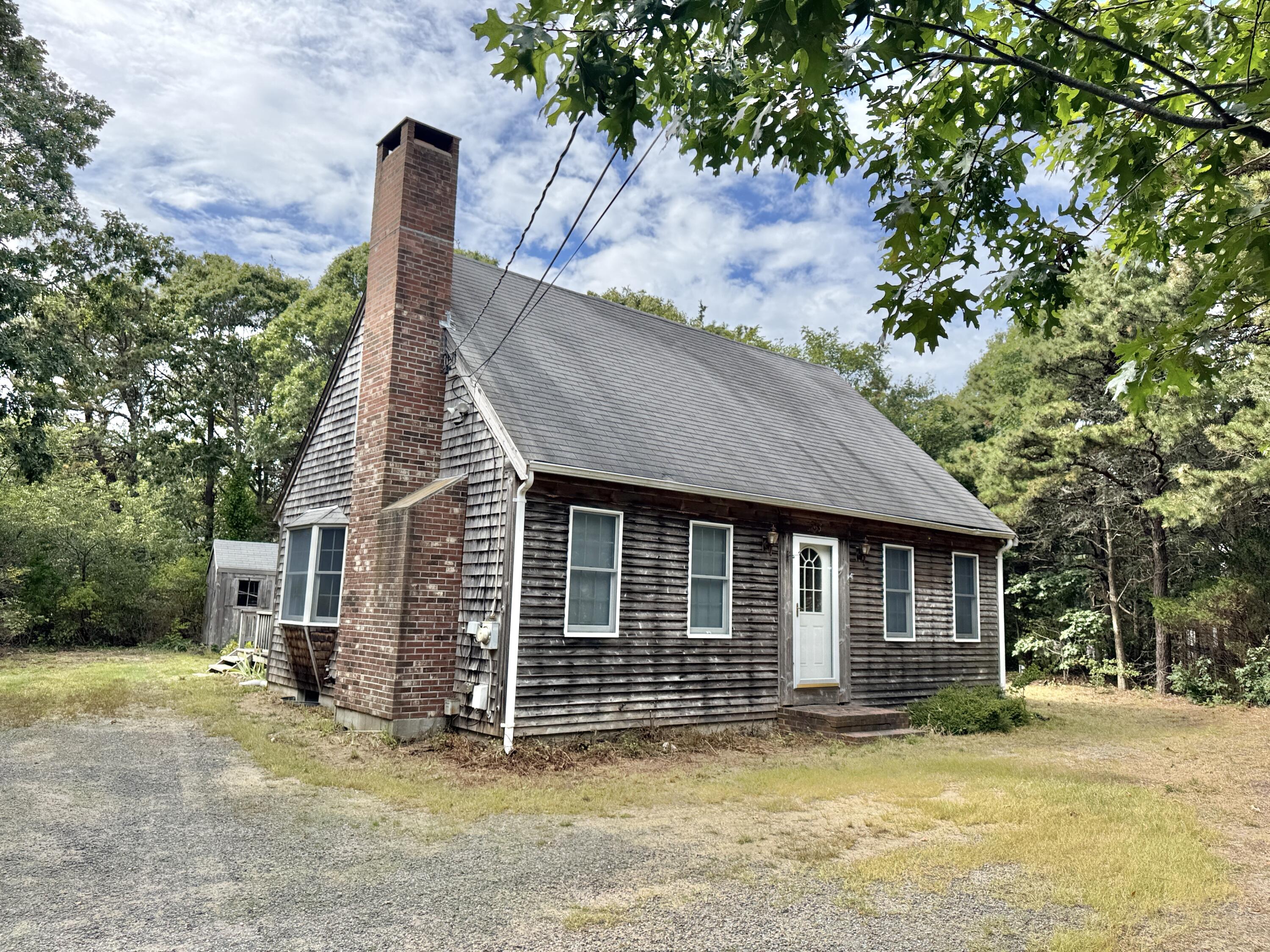 255 Massasoit Road Eastham, MA 02642 - Photo 3 of 25 a view of a house with a tub and trees in the background