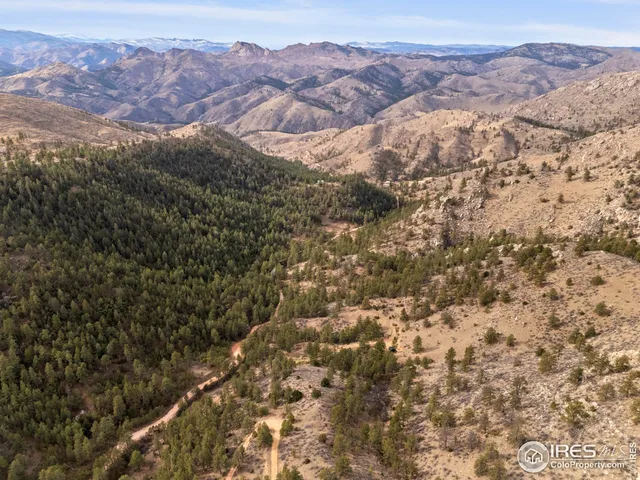a view of a large building with mountains in the background