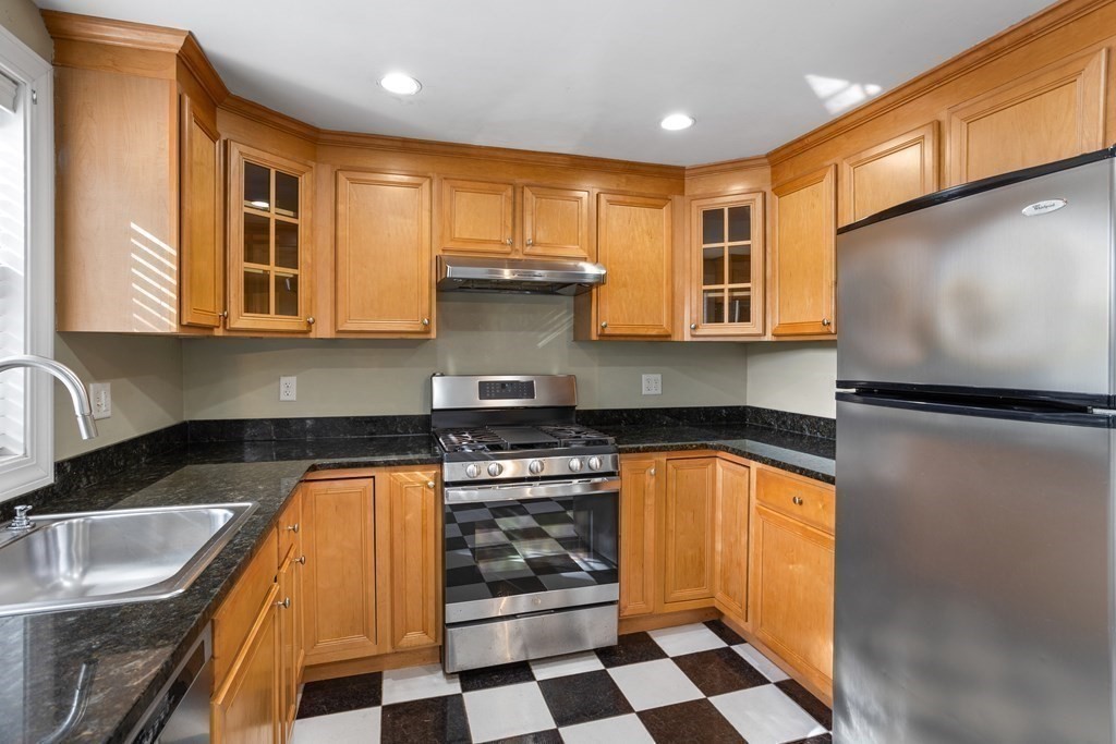 140 Lowell Street Lexington, MA 02420 - Photo 11 of 37 a kitchen with stainless steel appliances granite countertop a stove a sink and a microwave