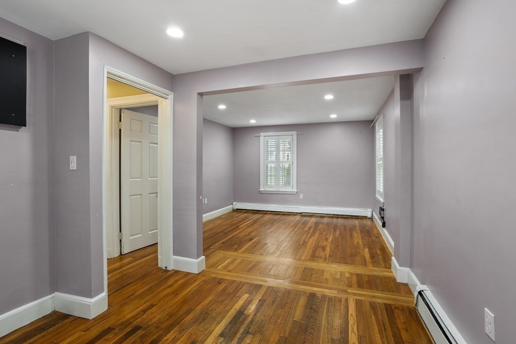 140 Lowell Street Lexington, MA 02420 - Photo 16 of 37 a view of an empty room with wooden floor and a window