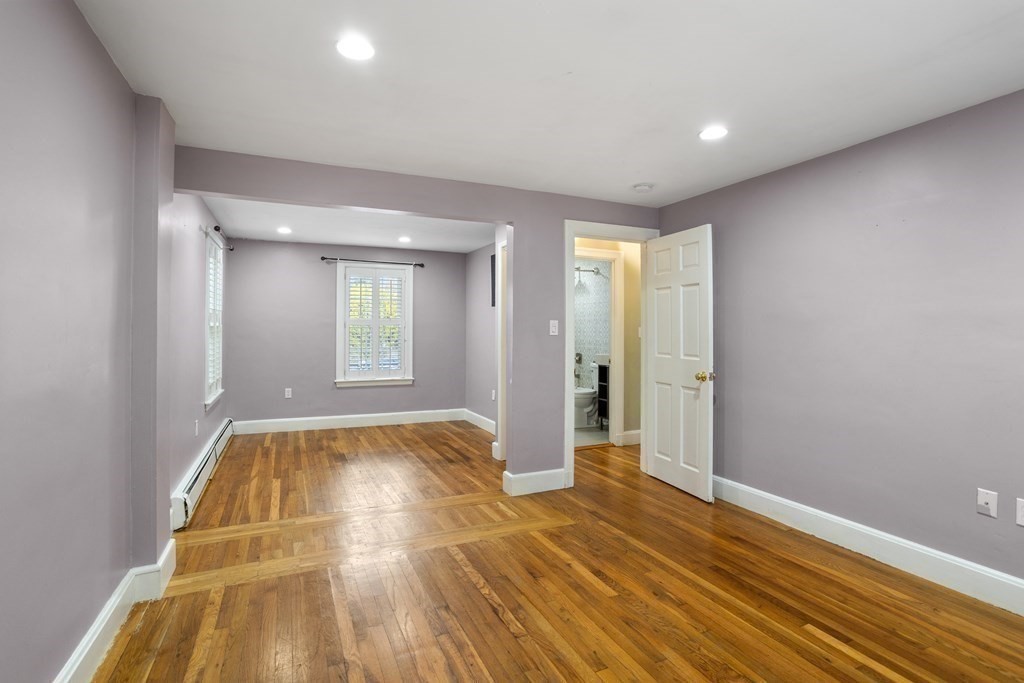 140 Lowell Street Lexington, MA 02420 - Photo 17 of 37 a view of an empty room with window and wooden floor