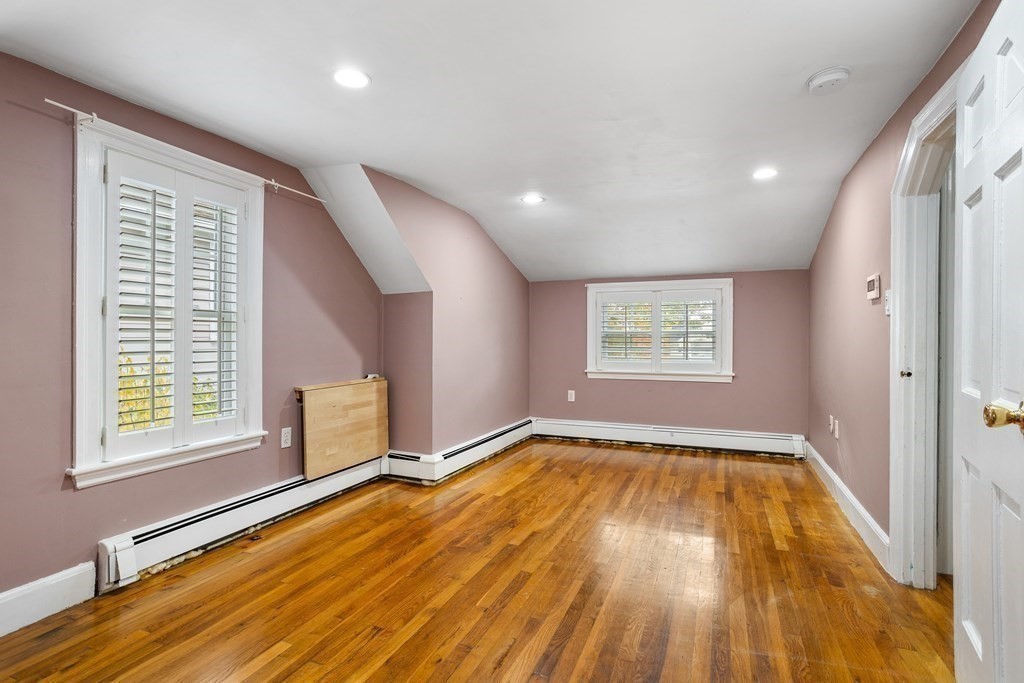 140 Lowell Street Lexington, MA 02420 - Photo 26 of 37 a view of an empty room with a window and wooden floor