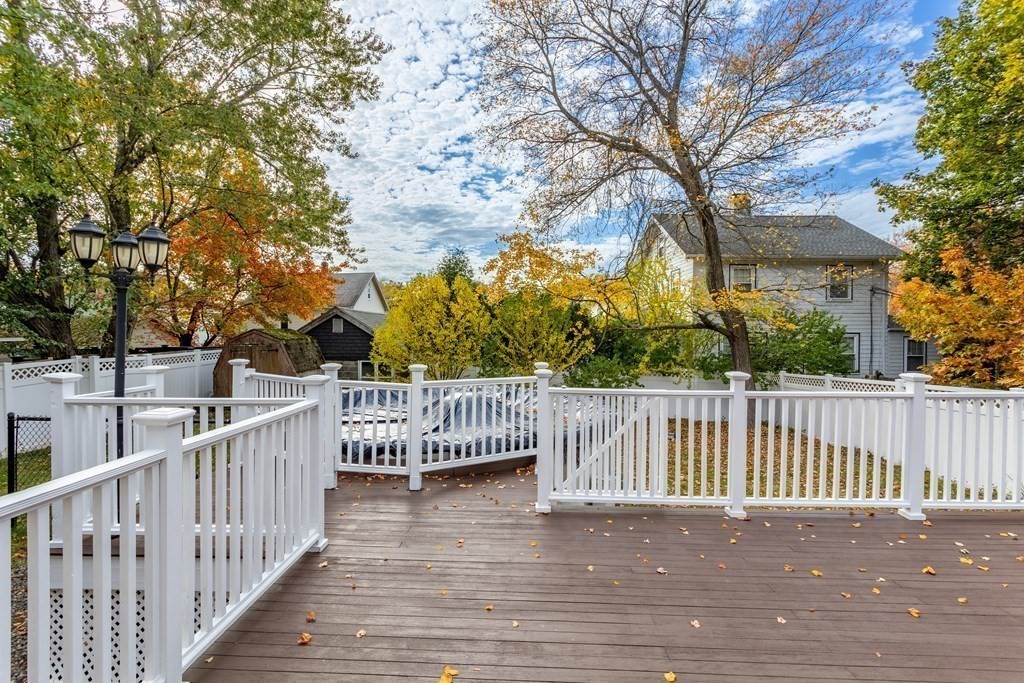 140 Lowell Street Lexington, MA 02420 - Photo 33 of 37 a view of a wooden deck and a forest