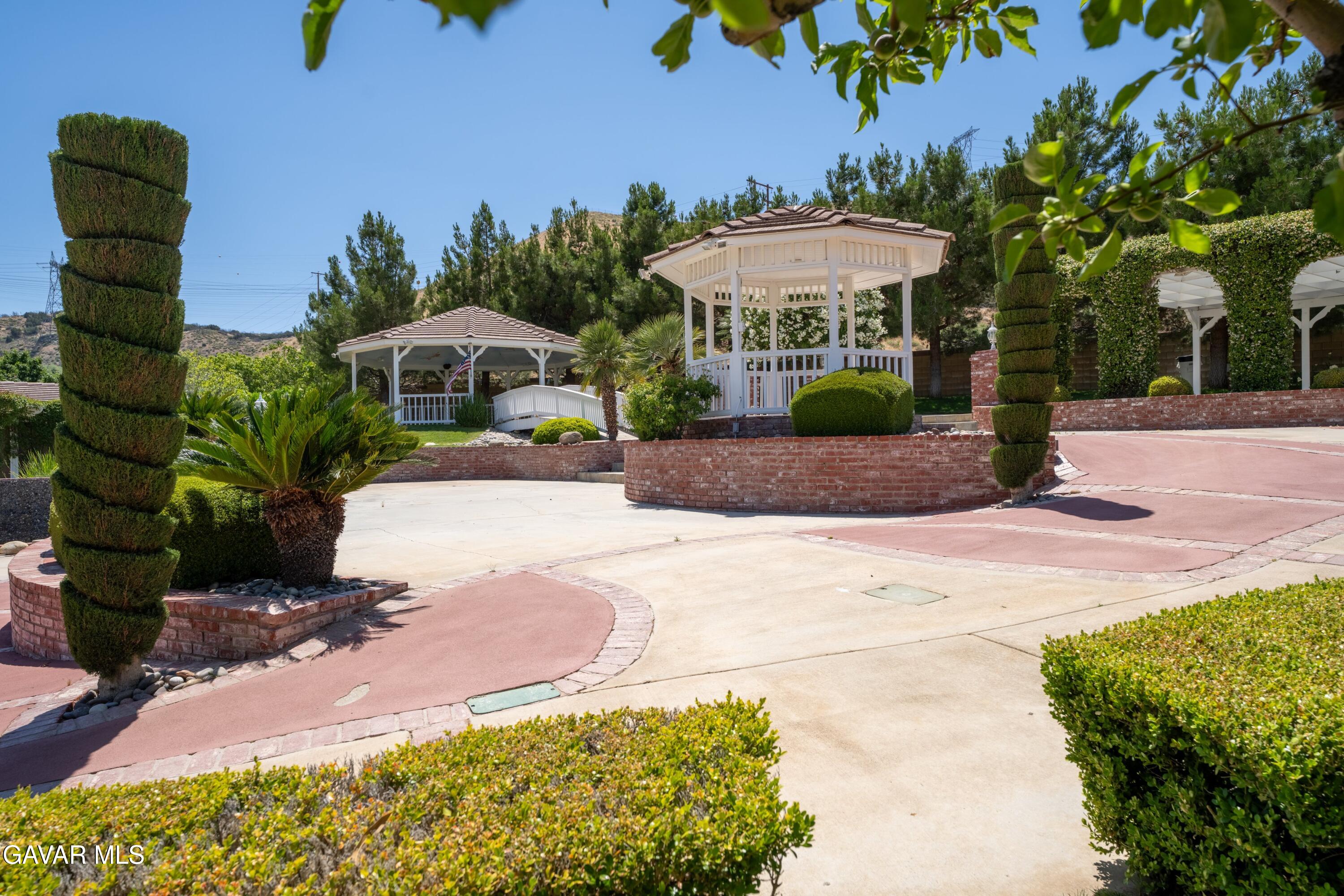 5801 Hacienda Ranch Road Palmdale, CA 93551 - Photo 49 of 69 a front view of a house with a yard