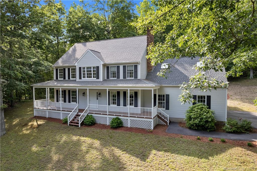 30 Break Neck Hill Road Westbrook, CT 06498 - Photo 1 of 1 a front view of a house with a yard table and chairs