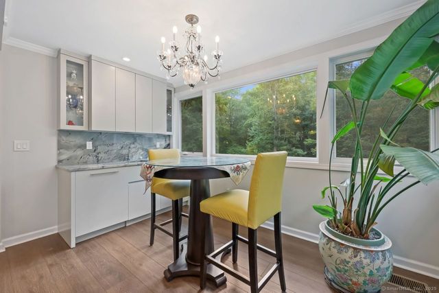 a dining room with furniture and a potted plant