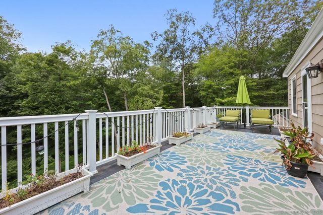 a view of balcony with wooden floor and fence