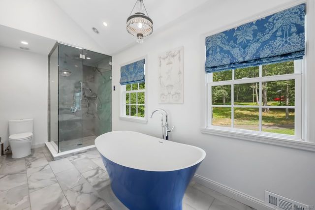 a bathroom with a toilet sink and shower