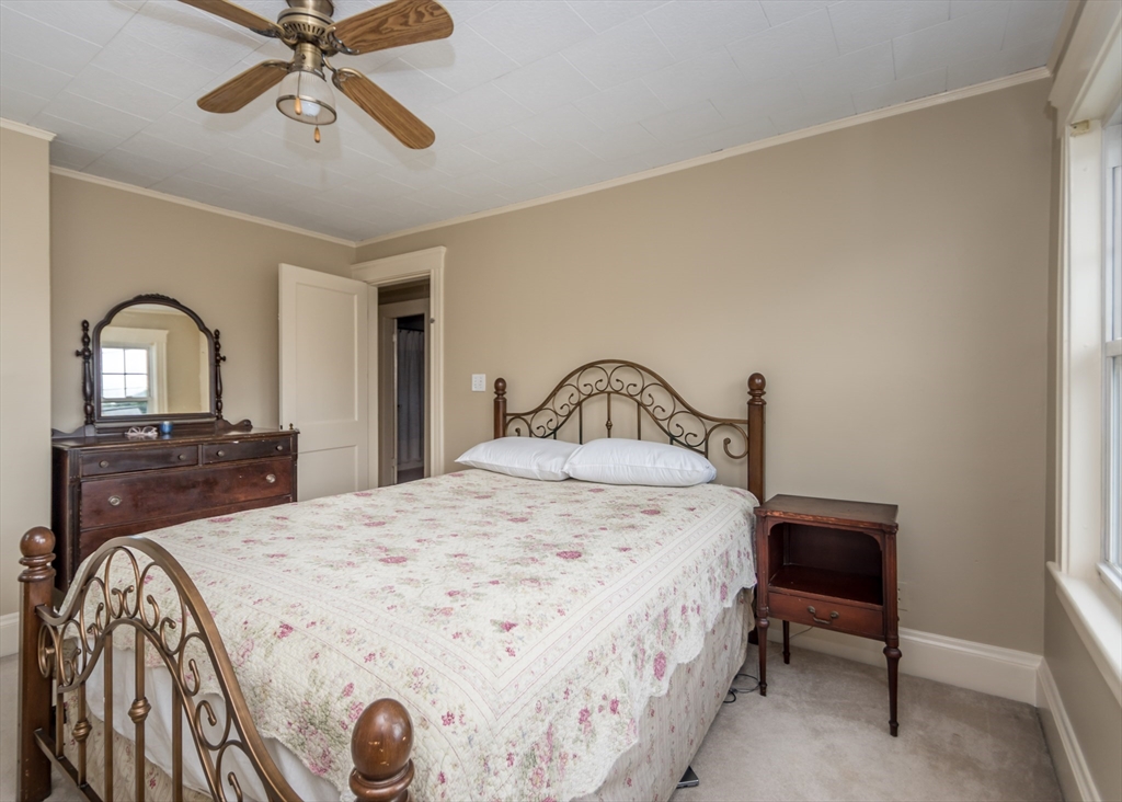 48 Bruce Road Waltham, MA 02453 - Photo 23 of 39 a bedroom with a bed and dresser with mirror