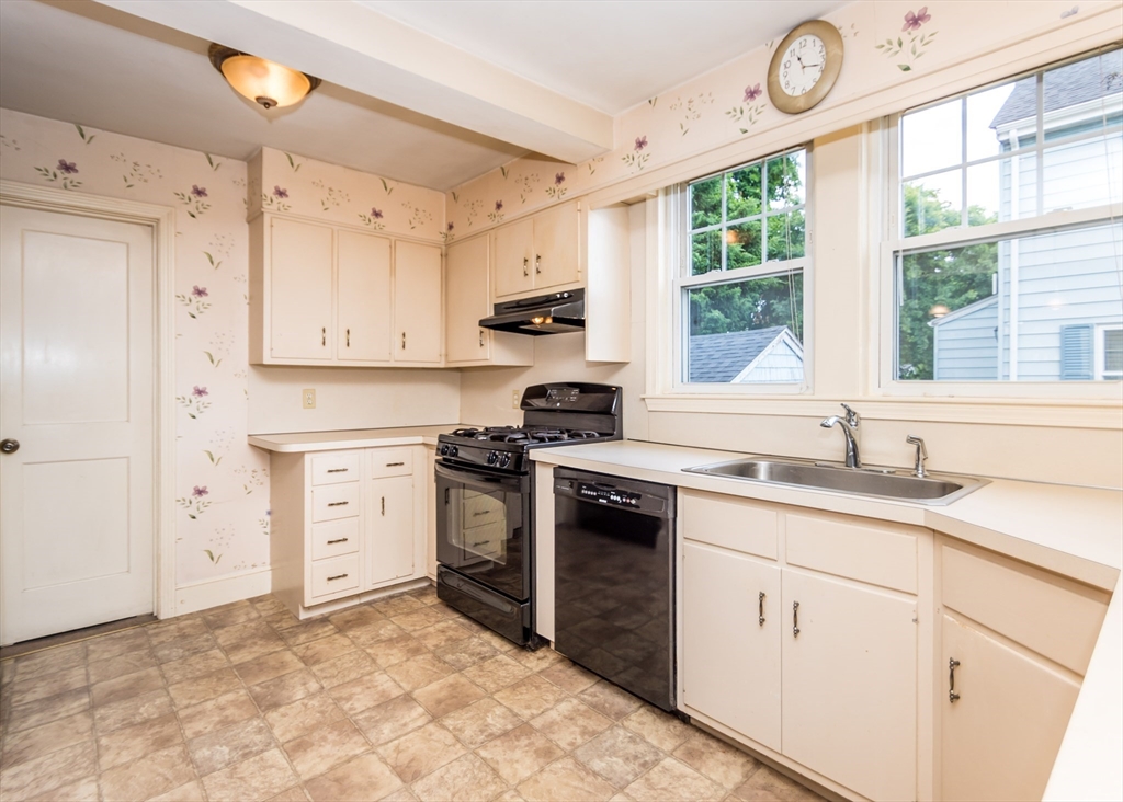 48 Bruce Road Waltham, MA 02453 - Photo 6 of 39 a kitchen with granite countertop a sink cabinets stainless steel appliances and a window