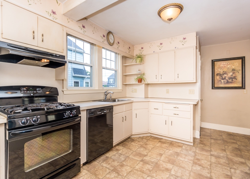 48 Bruce Road Waltham, MA 02453 - Photo 7 of 39 a kitchen with stainless steel appliances granite countertop a stove a sink and a microwave
