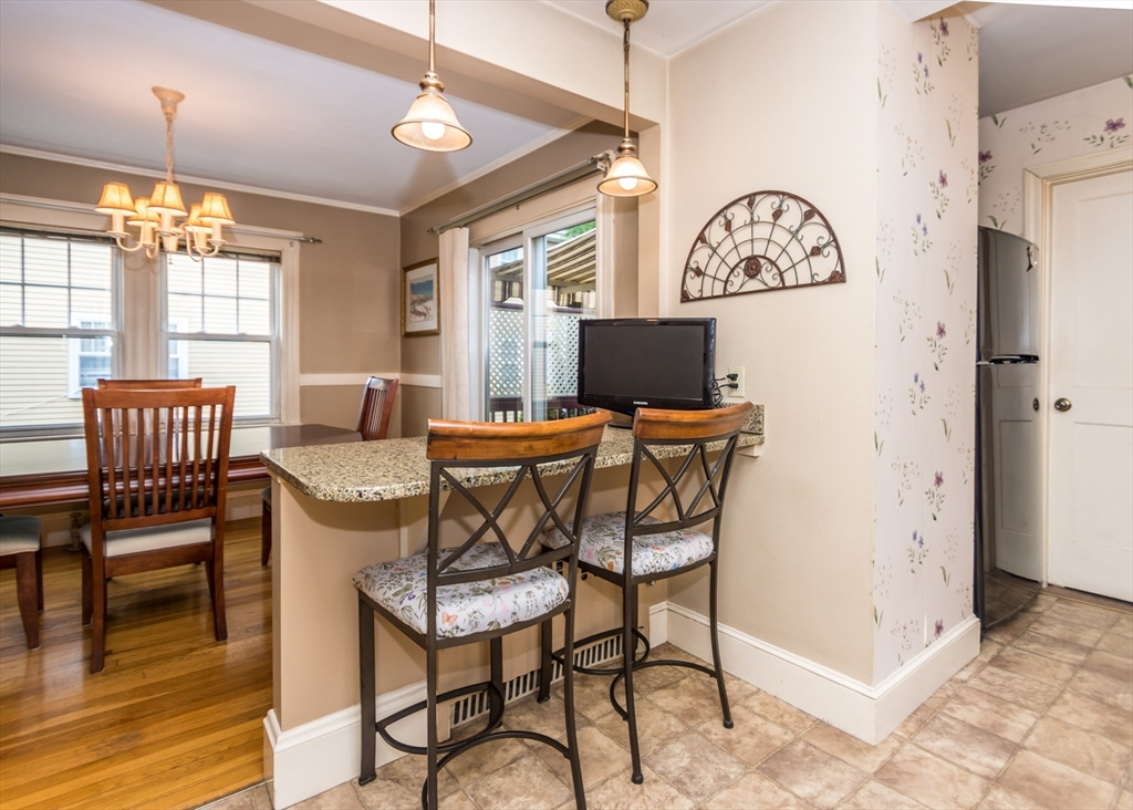 48 Bruce Road Waltham, MA 02453 - Photo 9 of 39 a dining room with furniture and wooden floor