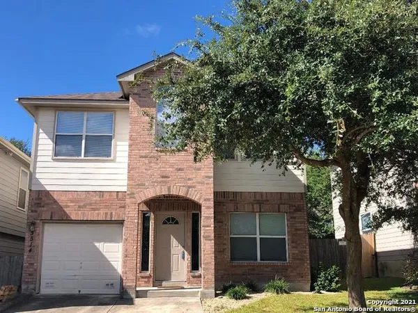 a front view of a house with parking