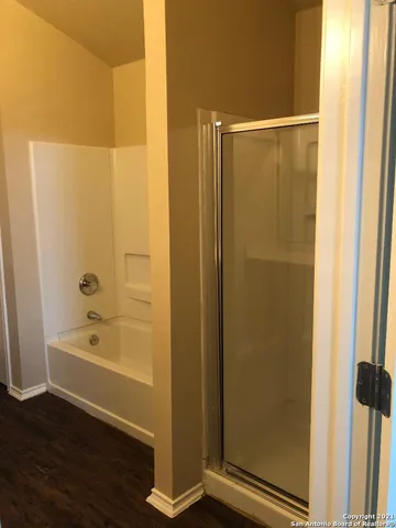 a bathroom with a bathtub and a shower
