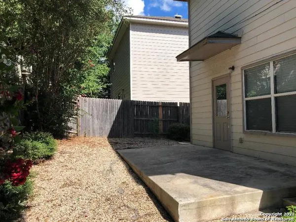 a view of small space in front of house