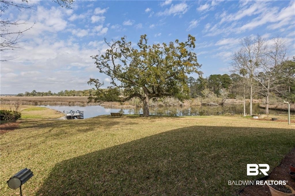 2730 Gator Road Mobile, AL 36605 - Photo 3 of 42 View of green lawn with a water view