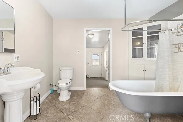 a bathroom with a toilet a sink and bathtub