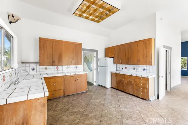 a large bathroom with a tub sink and mirror