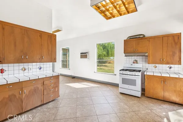 a kitchen with a stove a sink and a refrigerator