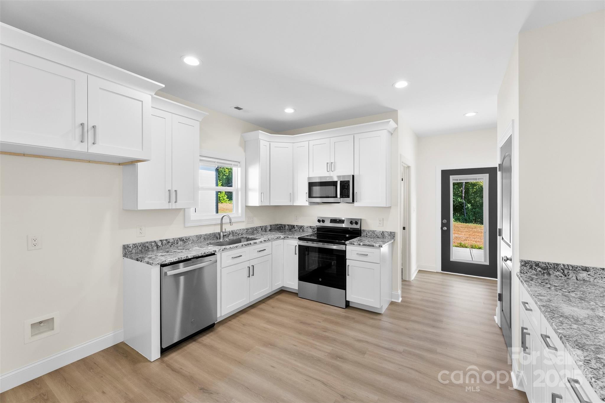 215 Benfield Road Kings Mountain, NC 28086 - Photo 12 of 25 a kitchen with stainless steel appliances granite countertop a stove top oven a sink and a granite counter tops with wooden floors