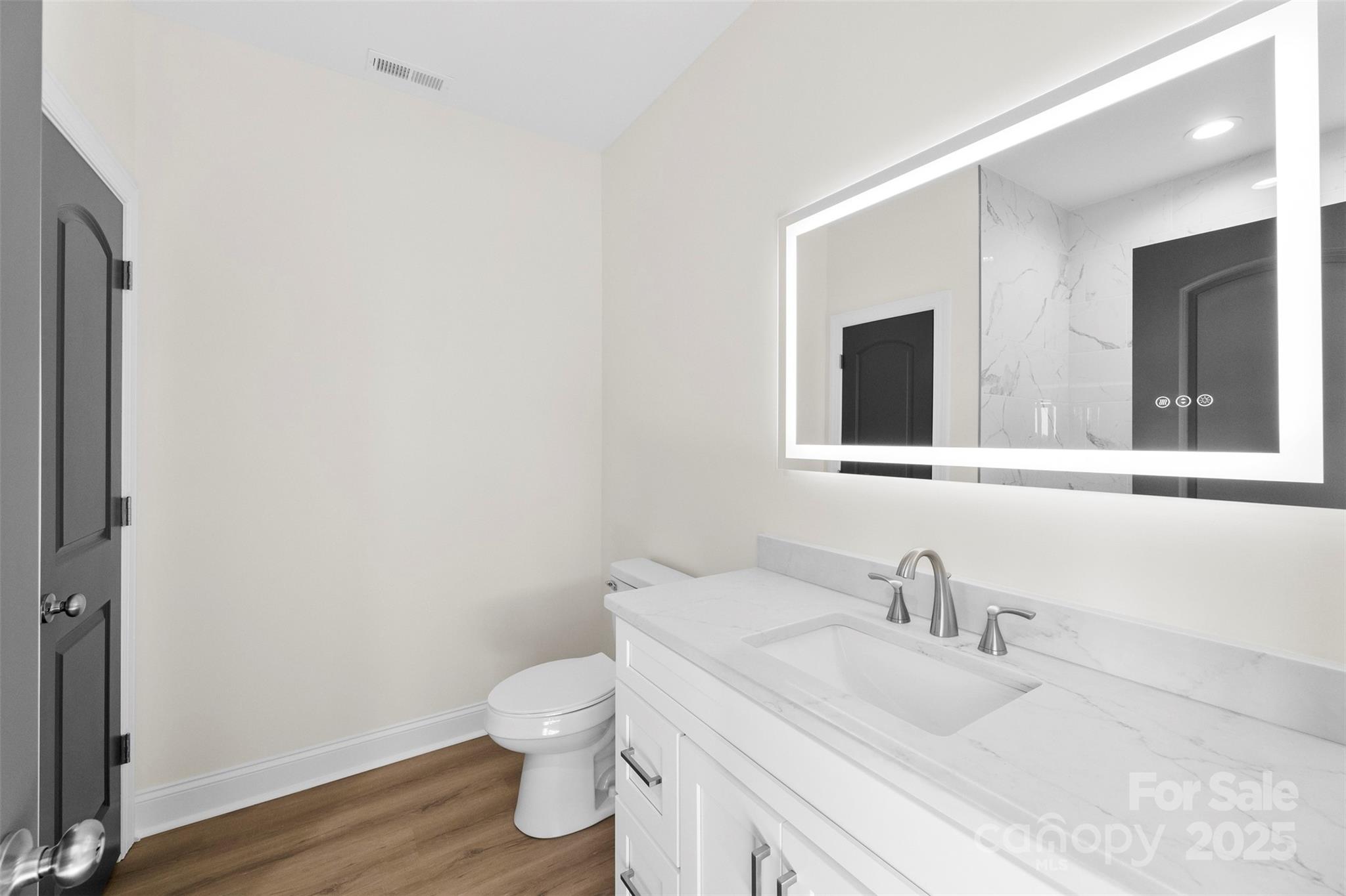 215 Benfield Road Kings Mountain, NC 28086 - Photo 18 of 25 a bathroom with a granite countertop toilet sink and mirror