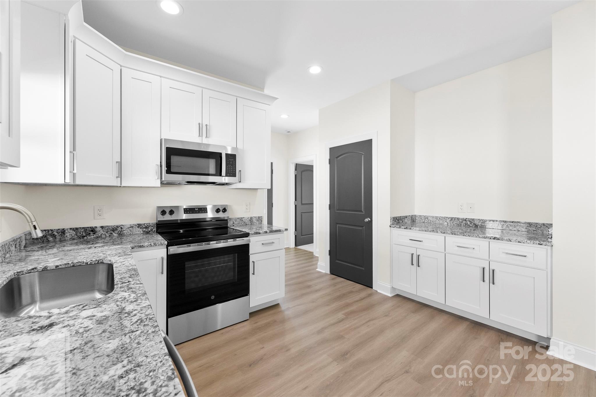 215 Benfield Road Kings Mountain, NC 28086 - Photo 20 of 25 a kitchen with granite countertop a refrigerator stove and sink