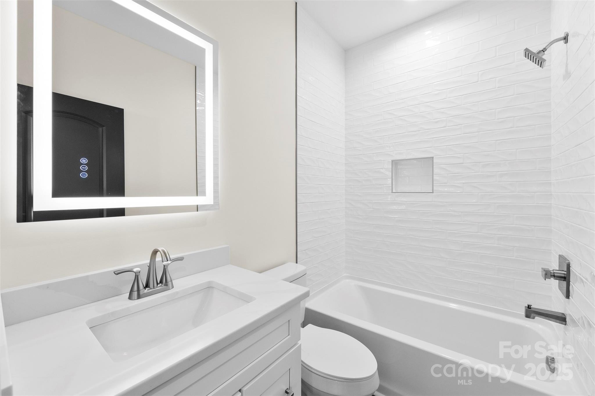 215 Benfield Road Kings Mountain, NC 28086 - Photo 23 of 25 a bathroom with a bathtub sink vanity mirror and toilet