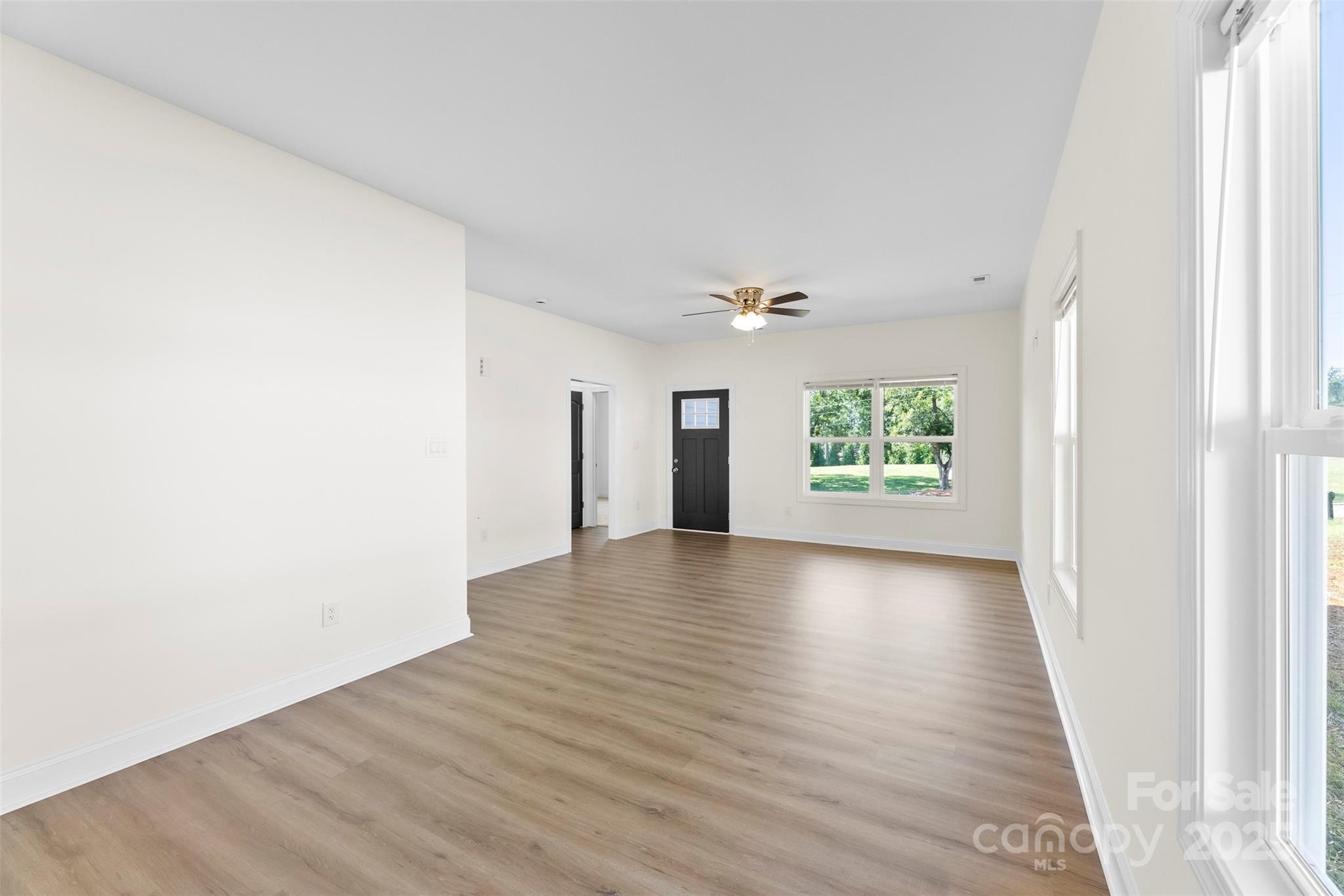 215 Benfield Road Kings Mountain, NC 28086 - Photo 10 of 25 a view of an empty room with wooden floor and a window