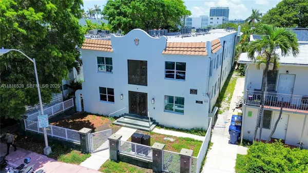 a aerial view of a house with swimming pool and next to a yard