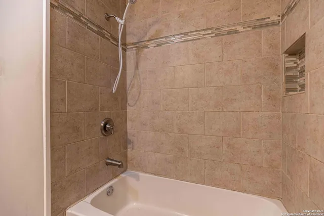 a bathroom with a shower and a bath tub