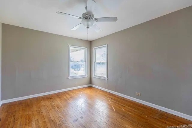wooden floor in an empty room with a window