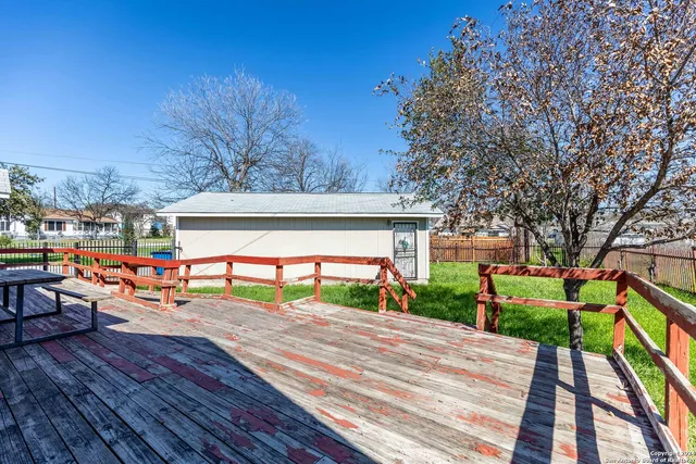 a view of a house with a backyard and sitting area