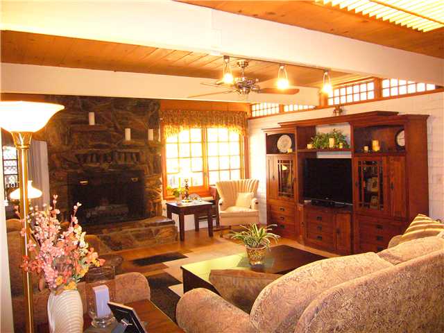 1330 East Fallbrook Street Fallbrook, CA 92028 - Photo 2 of 22 Large "Great" room, rock oversized "Petrified Wood" fireplace (Gas & Wood burning), wood beams & windows and skylight with shutters.