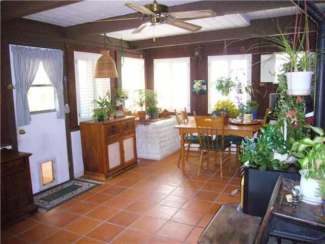1330 East Fallbrook Street Fallbrook, CA 92028 - Photo 12 of 22 Nicely done enclosed patio (Sun Room) with matching windows and doors. Wood stove for warming up.