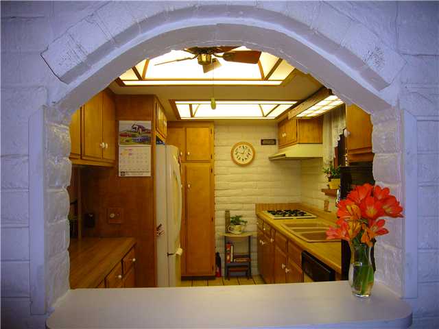 1330 East Fallbrook Street Fallbrook, CA 92028 - Photo 4 of 22 What a nice feature to have this arched pass-through between the Dining Room into the Kitchen. Kitchen also has a breakfast bar.