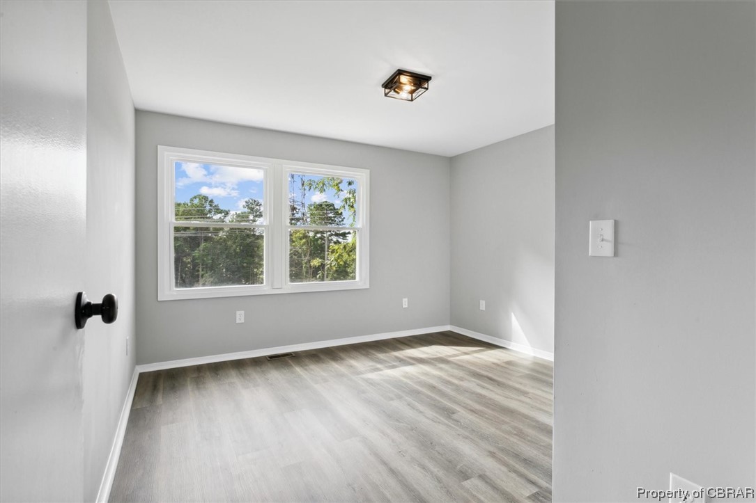 8636 Diascund Road Lanexa, VA 23089 - Photo 26 of 50 Spare room featuring light hardwood flooring