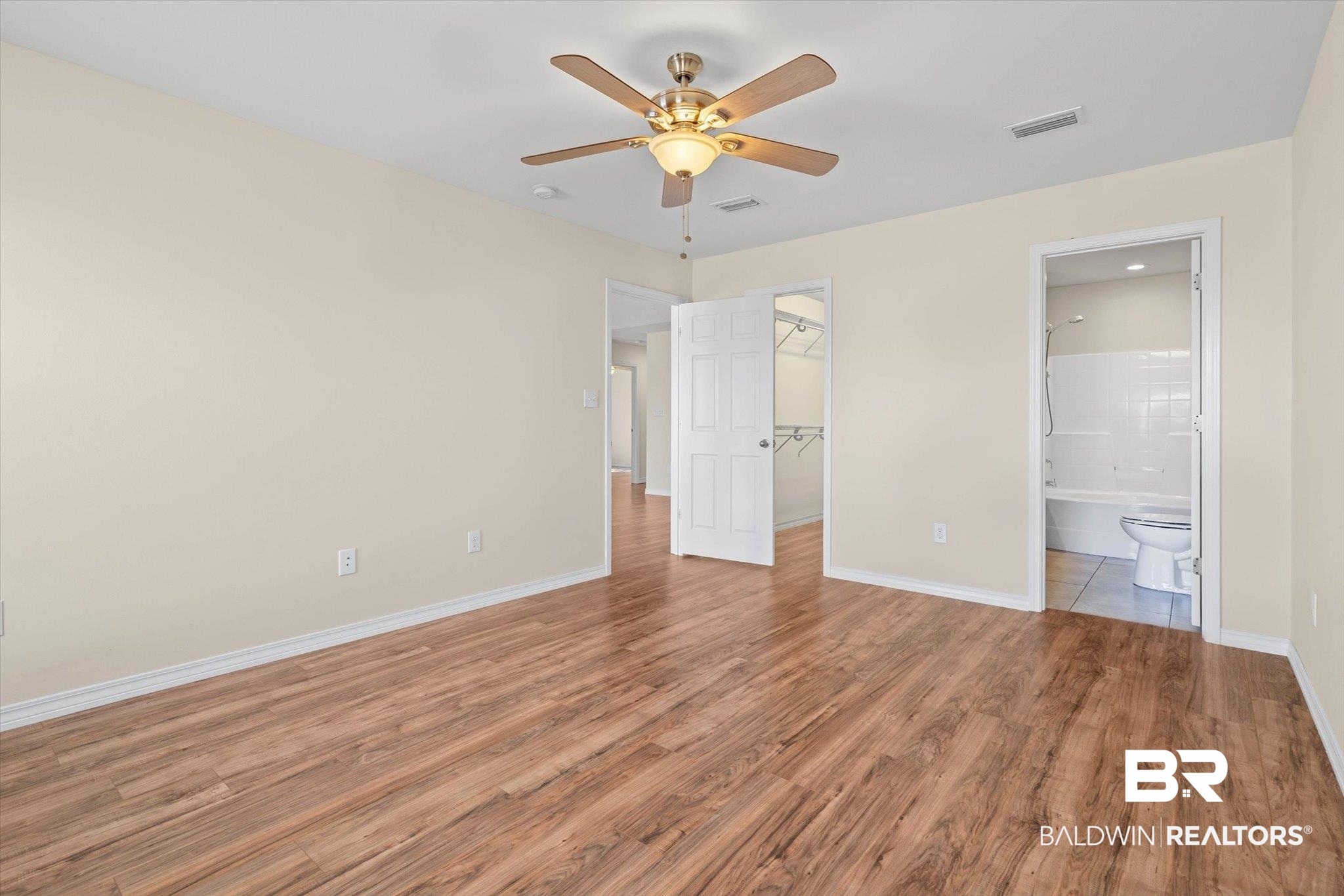 919 Sailor Circle Foley, AL 36535 - Photo 12 of 24 Unfurnished bedroom with a ceiling fan, light wood-type flooring, and a spacious closet