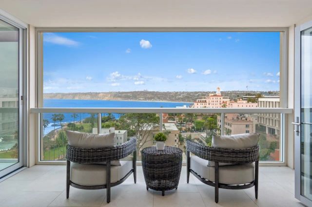 a view of a living room with furniture and a floor to ceiling window