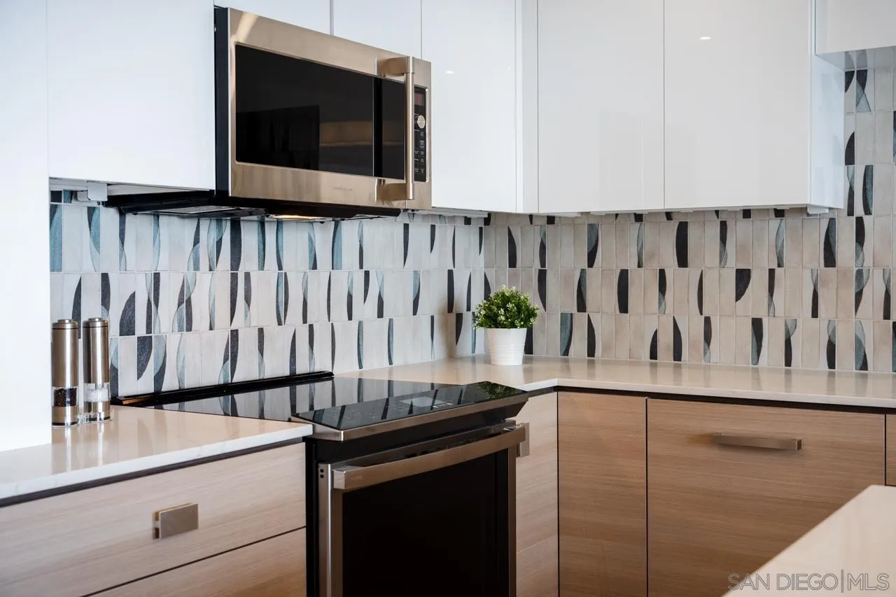 939 Coast La, Unit 16G La Jolla, CA 92037 - Photo 23 of 69 a kitchen with a stove and a microwave