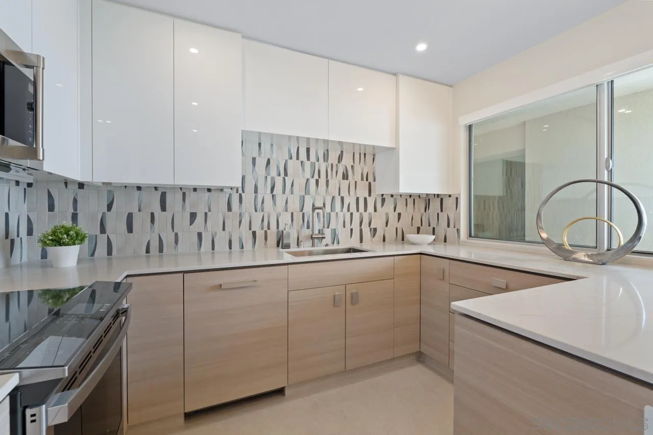 939 Coast La, Unit 16G La Jolla, CA 92037 - Photo 24 of 69 a kitchen with a sink and cabinets