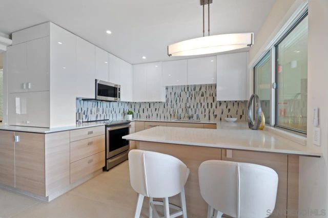 a balcony with furniture and a floor to ceiling window