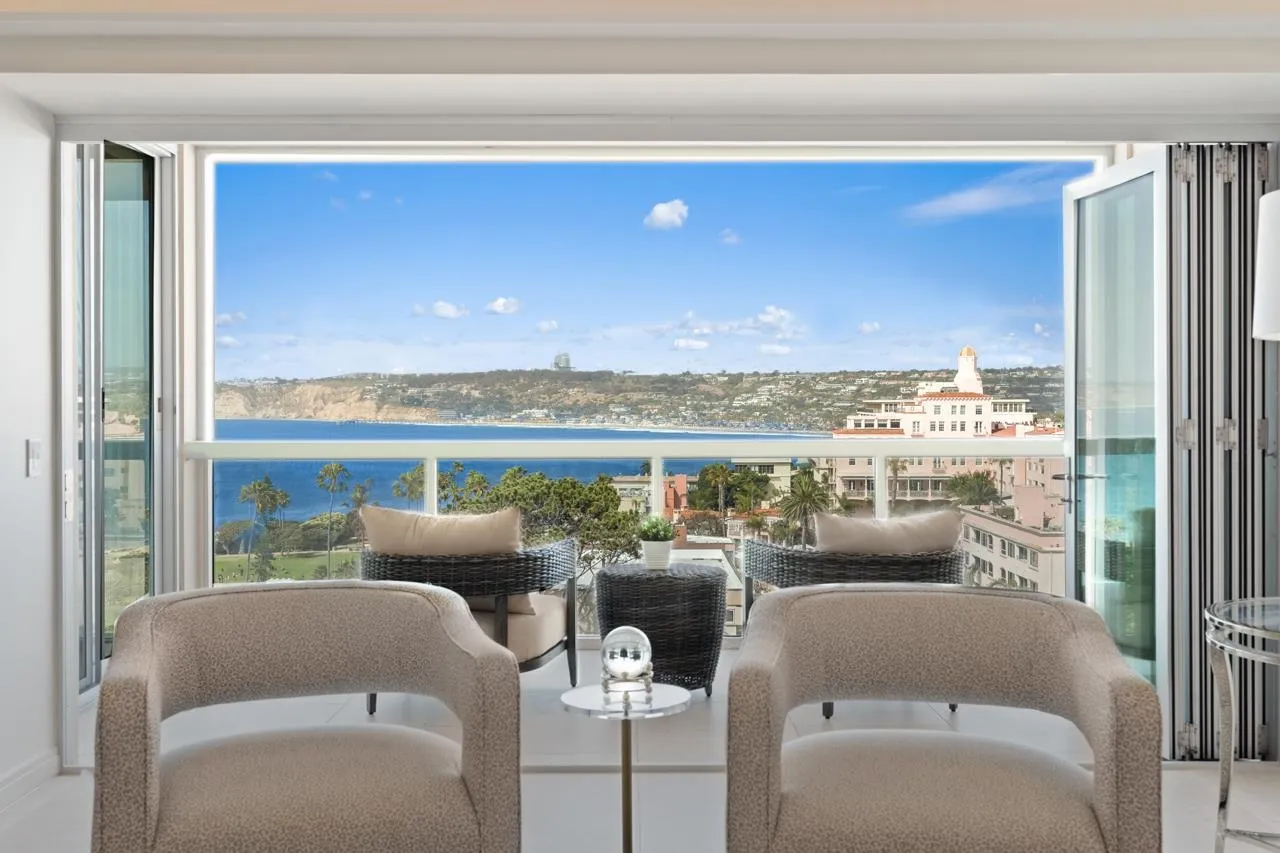 939 Coast La, Unit 16G La Jolla, CA 92037 - Photo 5 of 69 a living room with furniture a rug and a floor to ceiling window