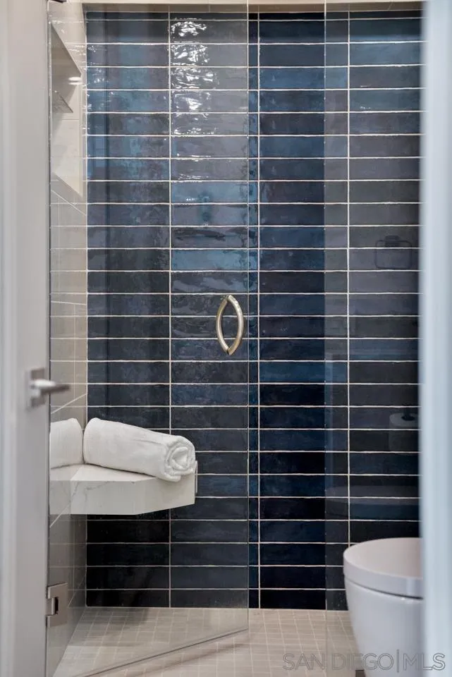 939 Coast La, Unit 16G La Jolla, CA 92037 - Photo 51 of 69 a bathroom with a sink a toilet and a mirror