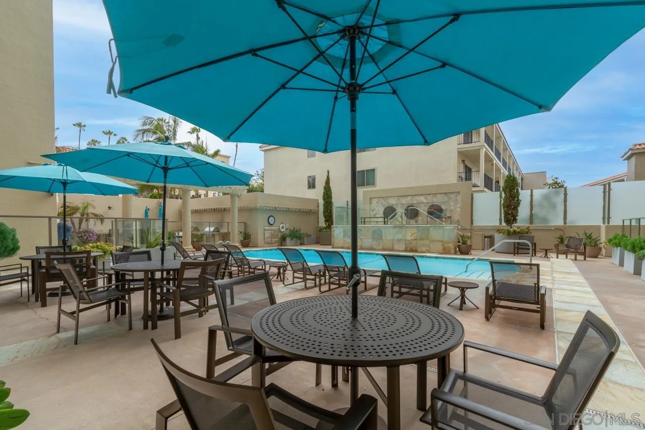 939 Coast La, Unit 16G La Jolla, CA 92037 - Photo 58 of 69 a view of a patio with a table and chairs under an umbrella